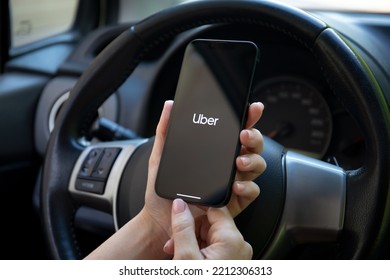 Alanya, Turkey - September 22, 2022: Woman Hand Holding IPhone 14 With Application Taxi Uber On The Screen In The Car.
