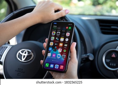 Alanya, Turkey - September 23, 2020: Woman Hand Holding IPhone 11 With Widgets Call Phone On The Screen IOS 14 In The Toyota Car.
