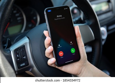 Alanya, Turkey - September 23, 2020: Woman Hand Holding IPhone 11 With Widgets Call Phone On The Screen IOS 14 In The Toyota Car.