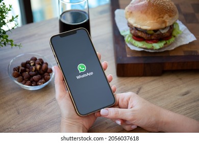 Alanya, Turkey - September 23, 2021: Woman Hand Holding IPhone 12 Pro Max Gold With Social Networking Service Messenger WhatsApp On The Screen.
