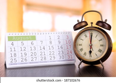Alarm clock  and calendar on bright background