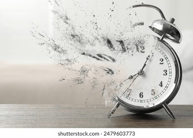 Alarm clock dissolving on table indoors. Time is running out