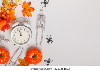 Alarm Clock With Fallen Leaves Pumpkins Skeletons Spiders. Transitional Change Of Autumn Time, Change Of Seasons Halloween