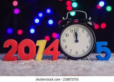 Alarm clock and figures in 2014 and 2015. - Powered by Shutterstock