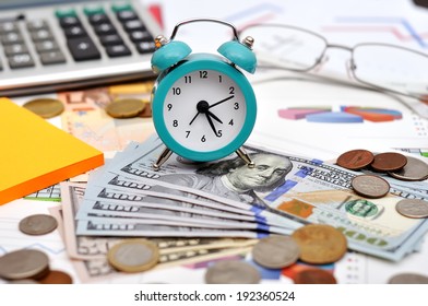 Alarm Clock, Money And Calculator On The Table