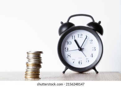 Alarm Clock And Money. Time Is Money. Coins On The Background Of The Clock. Money Leak. Payment Of Time According To The Price.