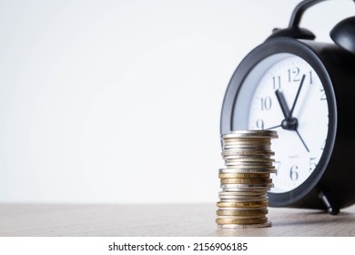 Alarm Clock And Money. Time Is Money. Coins On The Background Of The Clock. Money Leak. Payment Of Time According To The Price.