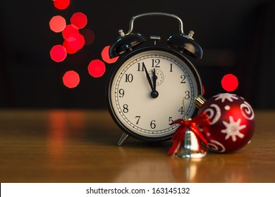 Alarm clock on a background of holiday lights.