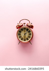 Alarm clock on a pink background, time 