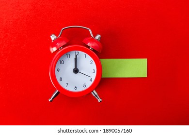Alarm clock on red background. Copy Space