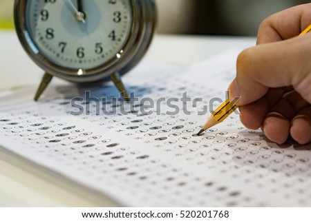 alarm clock, optical form of standardized test with bubbled and a black pencil examination,Answer sheet,education concept,selective focus,vintage