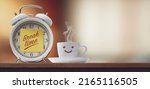 Alarm clock with sticky note and cute coffee cup smiling, it