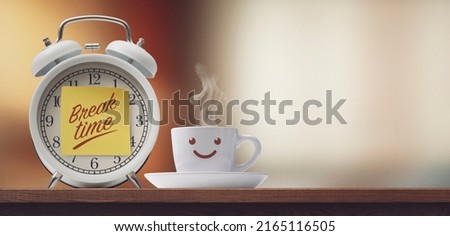Alarm clock with sticky note and cute coffee cup smiling, it's break time