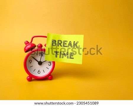 Alarm clock and sticky note with the word BREAK TIME on a yellow background