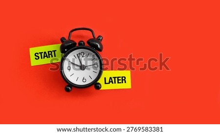 Alarm clock with sticky notes labeled Start and Later representing decision making, procrastination, and time management choices in daily life.