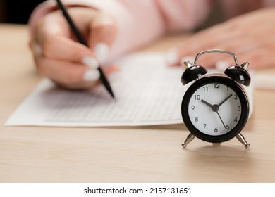 Alarm Clock For A Student Writing Exams, Taking An Exam Room With A Pencil Holding On An Optical Form Of A Standardized Test With Answers 