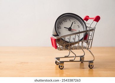 Alarm clock in supermarket trolley on wooden table with white wall background copy space. Buy time for work life balance or shopping promotion flash sale mega sale and time is money concept. - Powered by Shutterstock