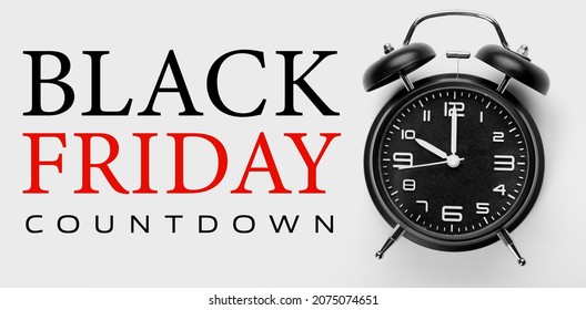 Alarm clock with text BLACK FRIDAY COUNTDOWN on light background