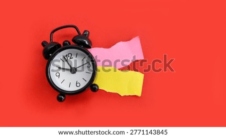 Alarm clock with torn sticky notes representing broken plans, change, and uncertainty.