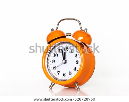 Alarm clock, watch hands showing midnight or noon.