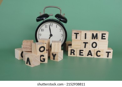 Alarm Clock With Wooden Cubes. Time To React Concept