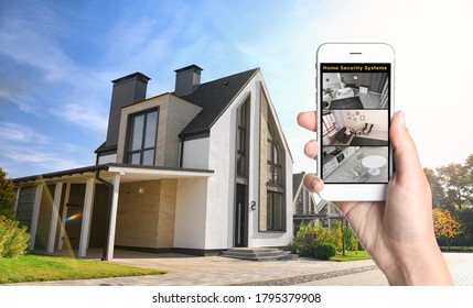 Alarm System. Woman Monitoring Modern CCTV Cameras On Smartphone Near Her House, Closeup