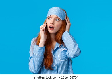 Alarmed And Disappointed, Upset Redhead Girl Woke Up Bad News, Calling Friend Telling Bad Dream Via Phonecall, Holding Smartphone Near Ear, Talking Look Uneasy And Anxious, Blue Background