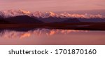 Alaska Coastal Mountain Range Reflection - The coastal mountain range across the Lynn Canal with alpenglow at sunset is reflected in a pool of water in the Chillkat Valley. Haines, Alaska.