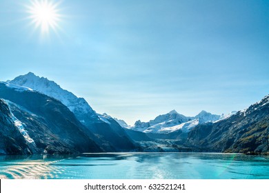 Alaska cruise travel landscape. Glacier Bay Johns Hopkins Glacier on sunny day with sun flare. Summer vacation in Alaska, USA.