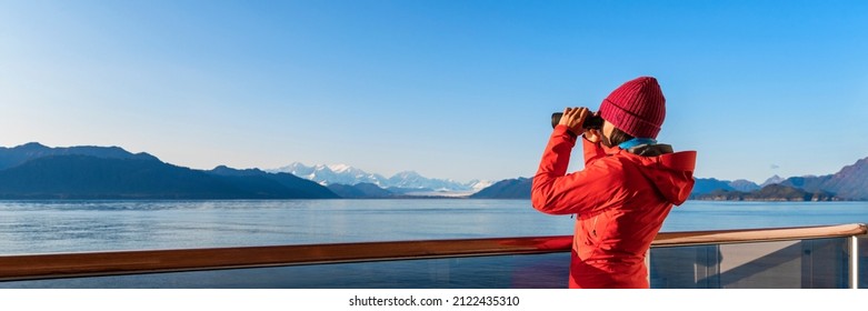 Alaska Glacier Bay cruise ship passenger looking at Alaskan mountains in binoculars exploring Glacier Bay National Park, USA. Woman on travel Inside Passage enjoying view. Vacation adventure banner. - Powered by Shutterstock