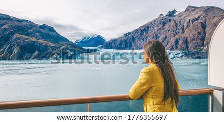 Alaska Glacier bay cruise ship travel tourist looking at icebergs inside passage from balcony deck view Scenic cruising vacation destination panoramic banner.