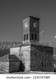 Gjirokastër (Albania) 30 August 2022. This Is The Famous Clock Tower Which Is Part Of The Ancient Castle Of Gjirokastër In Albania, Behind The Mali I Gjerë Mountain Range