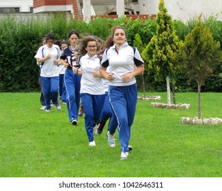 Lezhë, Albania - 5/22/2015 High School Girls Physical Education Class Running Around The Volleyball Field