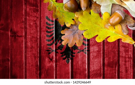 Albania flag on autumn wooden background with leaves and good place for your text. - Powered by Shutterstock