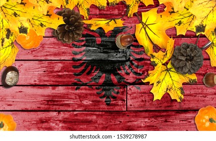 Albania flag on autumn wooden background with leaves and good place for your text - Powered by Shutterstock