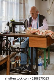 Albania, May 12, 2022 - Man Works At Tread-powered Sewing Machine