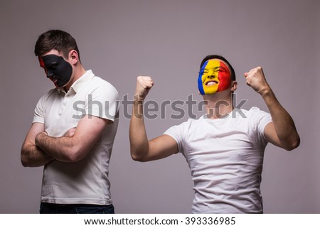 Albania vs Romania on grey background. Football fans of national teams demonstrate emotions: Albania Ã¢?? lose, Romania Ã¢?? win. European 2016 football fans concept.