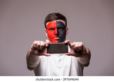 Albanian Football Fan Take Selfie Photo With Phone On Grey Background. European 2016 Football Fans Concept.