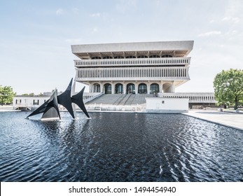 Albany New York - May 20th, 2017: Alexander Calder's Triangles and Arches Sculptures float on top of the water in the reflecting pool in front of the iconic concrete State Museum.