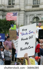 ALBANY, NY- SEPT 10: Protesers Hold Signs Against Universal Healthcare During A Stop Of The Tea Party Express Tour On September 10, 2009 In Albany NY