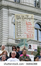 ALBANY, NY- SEPT 10: Protesters Hold Signs Against Wasteful Government Spending And Corrupt Career Politicians During A Stop Of The Tea Party Express Tour On September 10, 2009 In Albany NY