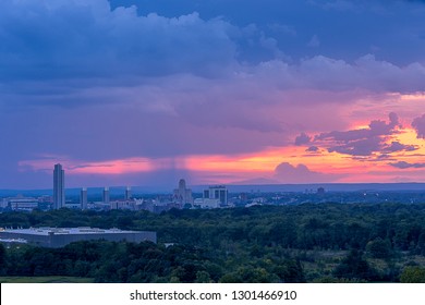 Albany NY Skyline At Sunset With A Storm Approaching And Rain In The Background.