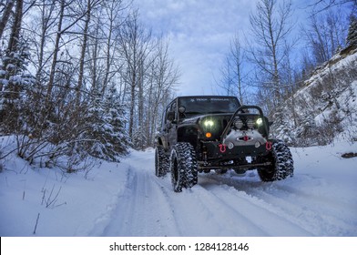 Alberta, Canada - December 12, 2018: Black Jeep Wrangler JK Unlimited Rubicon On Winter Mountain Trail