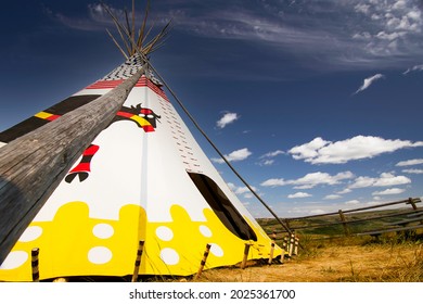 Alberta Alberta Canada, July 30 2021: An indigenous Teepee set up at Head Smashed in Buffalo Jump world heritage site under a blue summer sky.