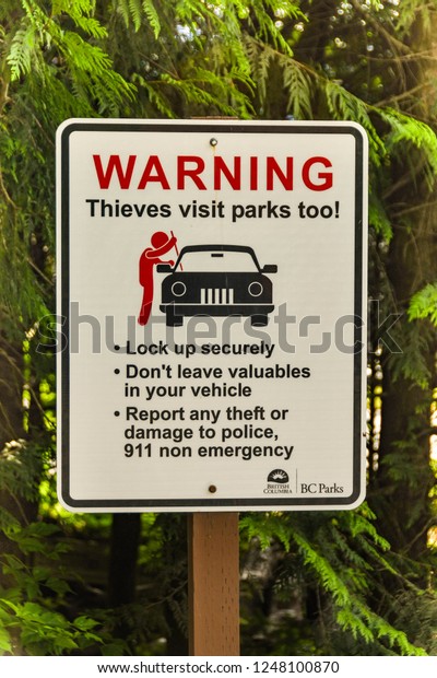ALBERTA,\
CANADA - MAY 2018: Sign in a public car park in Alberta warning\
visitors to lock their cars to prevent\
theft.