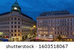 Albertina Square aerial day to night transition timelapse with illuminated historic buildings, tourist buses, people and traffic in downtown Vienna, Austria