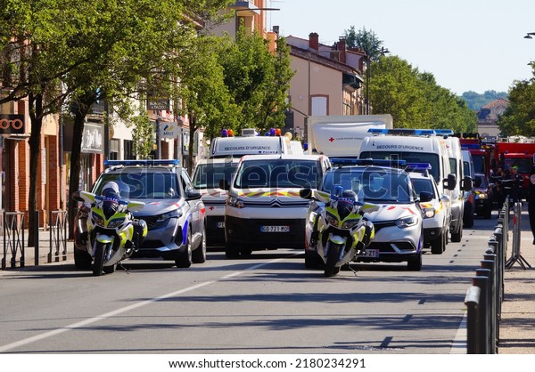 Albi, France - July 14, 2022 - A massive\
motorcades composed of police motorbikes and patrol cars, vans of\
the Civil Protection and French Red Cross, preparing for the\
National Day military\
parade