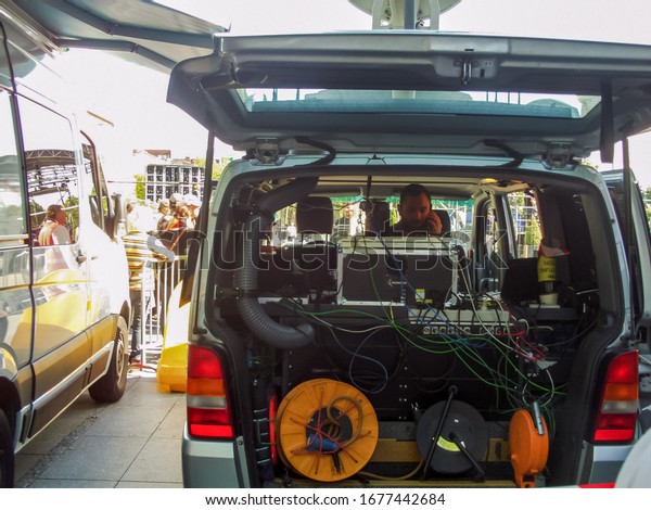 Albi, France - May 4, 2017 - A technician/engineer\
of a television crew inside a technical vehicle full of power\
cables and extension cords, providing the media coverage of E.\
Macron\'s election rally