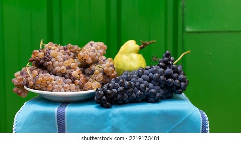 Albillo Grapes And Tempranillo Grapes With An Apple