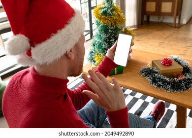 Albino african american man wearing santa hat making video call on smarphone with copy space. christmas, festivity and communication technology festivity and communication technology. - Powered by Shutterstock